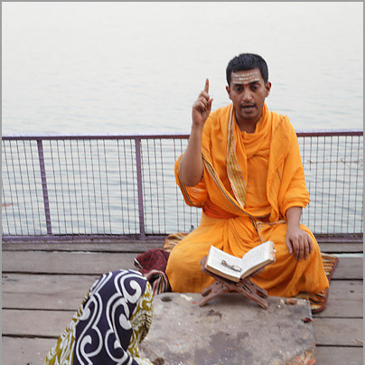 Pandit reading a Hindu astrology text